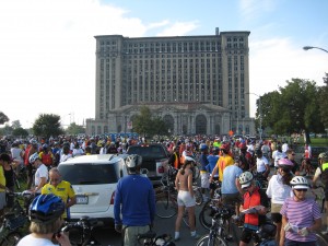 Cyclists get ready to roll in front of the old Michigan Central Station